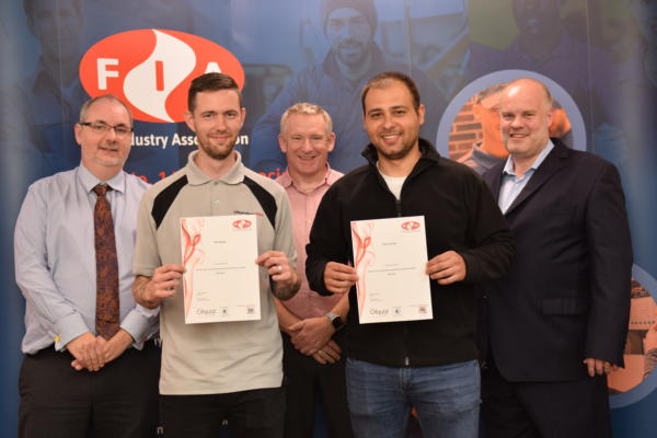 The first two people to achieve a qualification are presented certificates